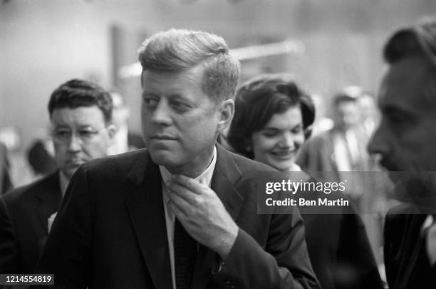 John F Kennedy and wife Jacqueline Kennedy arrive with advisors for split-screen telecast of the Presidential debate with Nixon and panelists in ABC...