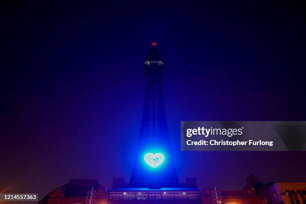 The iconic Blackpool Tower is adorned with a blue heart in honour of the British National Health Service and frontline staff who are fighting against...