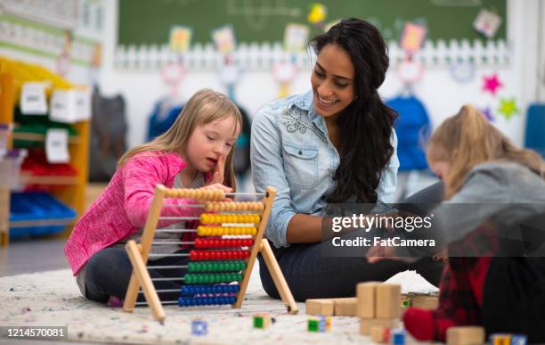 young elementary school students learning stock photo - special education stock pictures, royalty-free photos & images