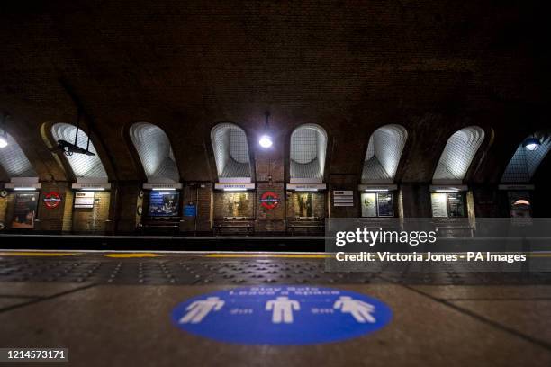 An information sticker regarding social distancing rules on a platform at Baker Street tube station in London on Sherlock Holmes Day, after the...