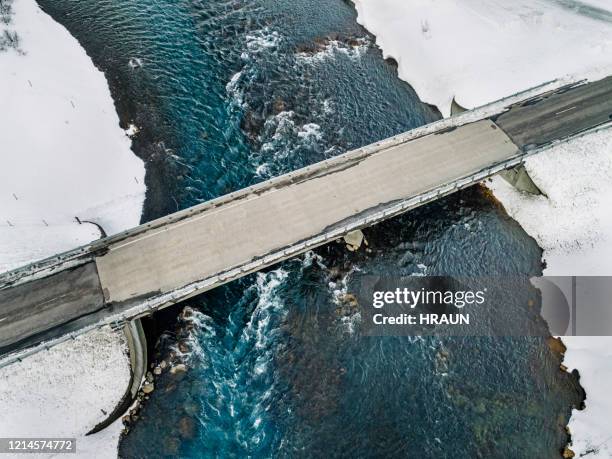 aerial of  a bridge in iceland covered in snow - bridging the gap stock pictures, royalty-free photos & images