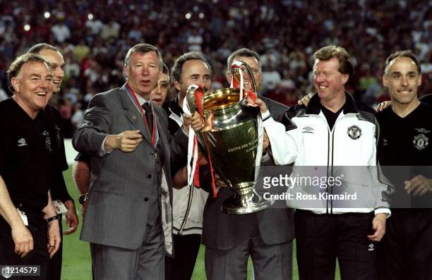 Manchester United manager Alex Ferguson and assistant Steve McClaren celebrate with the trophy after victory over Bayern Munich in the UEFA Champions...
