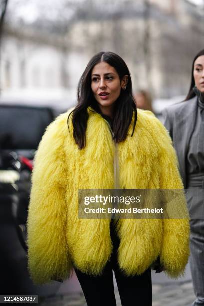 Gilda Ambrosio wears a yellow fluffy faux fur coat, outside Alessandra Rich, during Paris Fashion Week - Womenswear Fall/Winter 2020/2021, on...