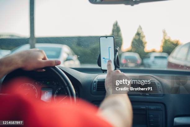 delivery man using gps on his smart phone - van driver stock pictures, royalty-free photos & images