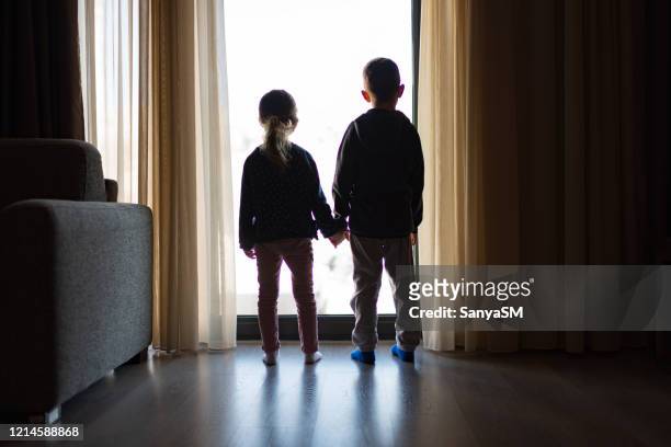 looking trough the window - sibling stock pictures, royalty-free photos & images