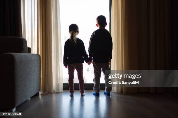 looking trough the window - child rear view stock pictures, royalty-free photos & images