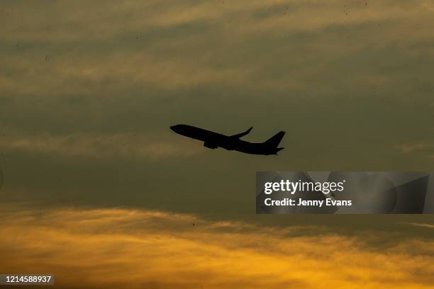 Plane is seen after takeoff at Sydney airport on March 25, 2020 in Sydney, Australia. Prime Minister Scott Morrison announced further restrictions on...