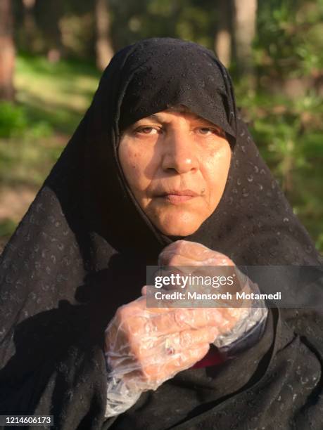 covering hands by gloves for corona virus - iran women stock pictures, royalty-free photos & images