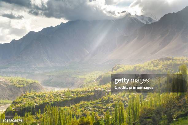 natural view along karakorum mountains at hunza valley with cherry blossom autumn season pakistan - himalayas sunrise stock pictures, royalty-free photos & images