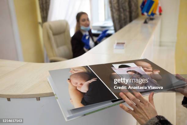 Photo album of infants and their parents who were clients of BioTexCom clinic, as seen on the Venice Hotel reception desk on May 22, 2020 in Kyiv,...