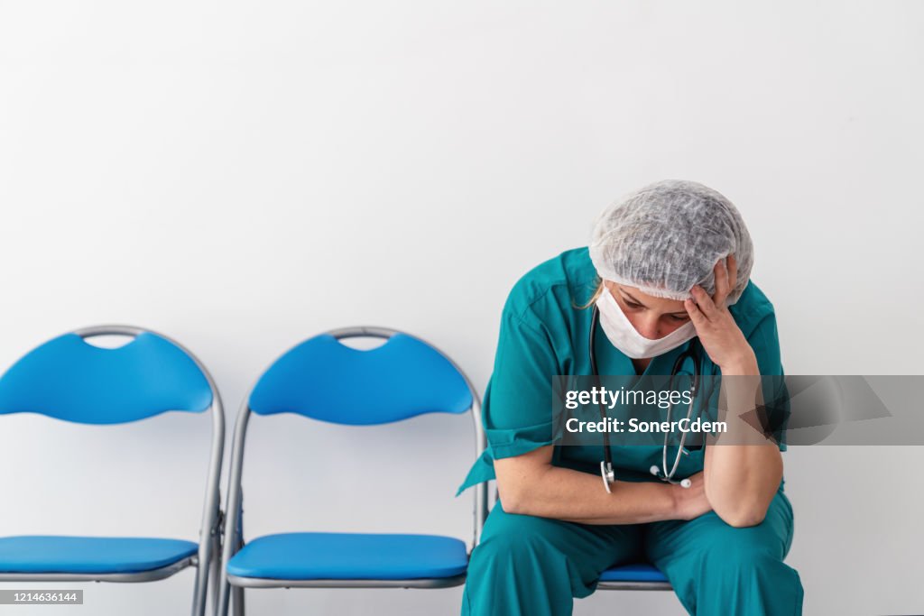 Woman doctor is sitting and has, worry, frustration, tiredness and exhausting deep feelings.