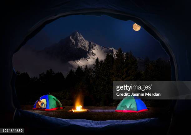 my tent open door to our camp set in mountain in beautiful peaceful night - zelt nacht stock-fotos und bilder
