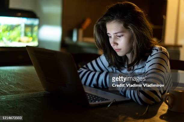 teenage girl in front of computer late at night - abused girl stock pictures, royalty-free photos & images
