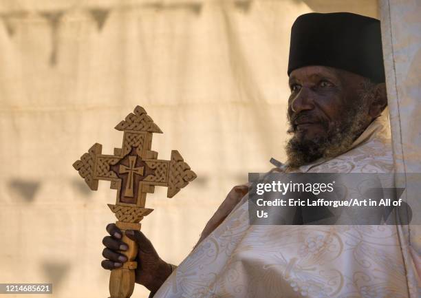 Priest with a cross in Entoto orthodox Maryam Church, Addis Ababa Region, Addis Ababa, Ethiopia on December 1, 2019 in Addis Ababa, Ethiopia.