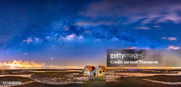 twin house in the middle of the stars and the milky way, located in phatthalung province, in the southern part of thailand. - phatthalung province stock-fotos und bilder