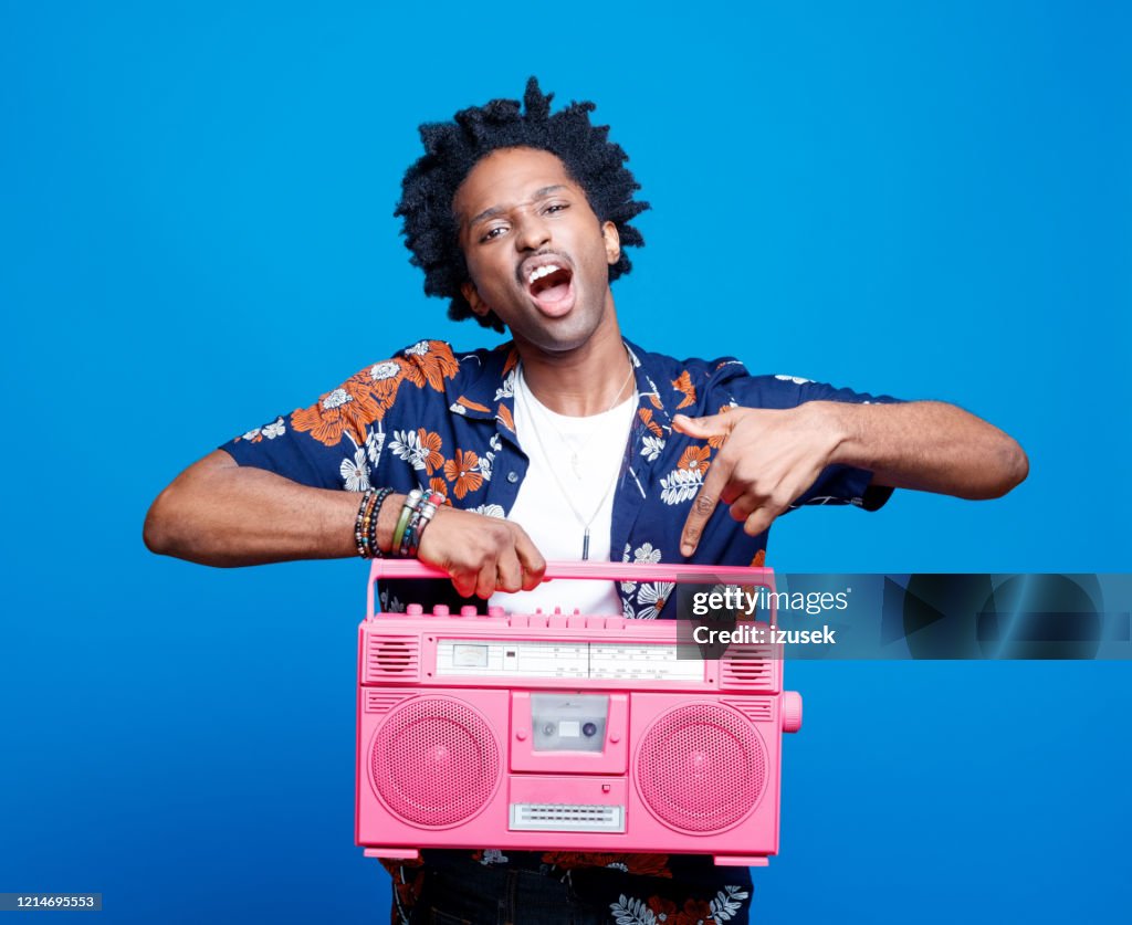 Rapper in hawaiian shirt holding pink boom box