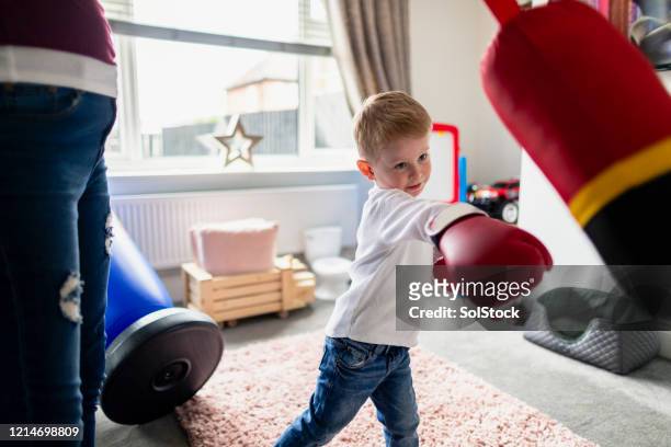 swing and a hit! - kid punching stock pictures, royalty-free photos & images