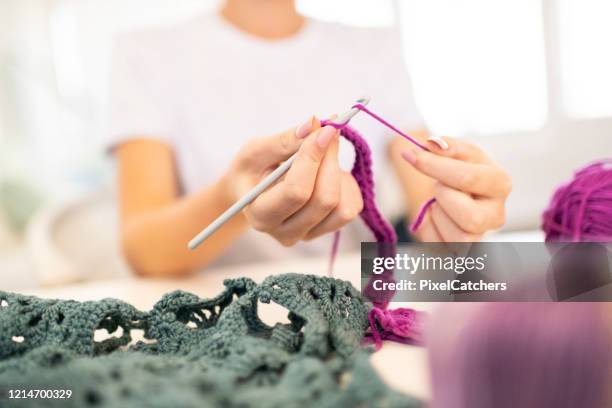 close up young woman crocheting with needle and wool - crochet stock pictures, royalty-free photos & images
