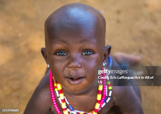 Larim tribe baby girl with necklaces, Boya Mountains, Imatong, South Sudan on February 6, 2020 in Imatong, South Sudan.