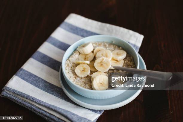 oatmeal, banana, cream and maple syrup - oatmeal stock pictures, royalty-free photos & images