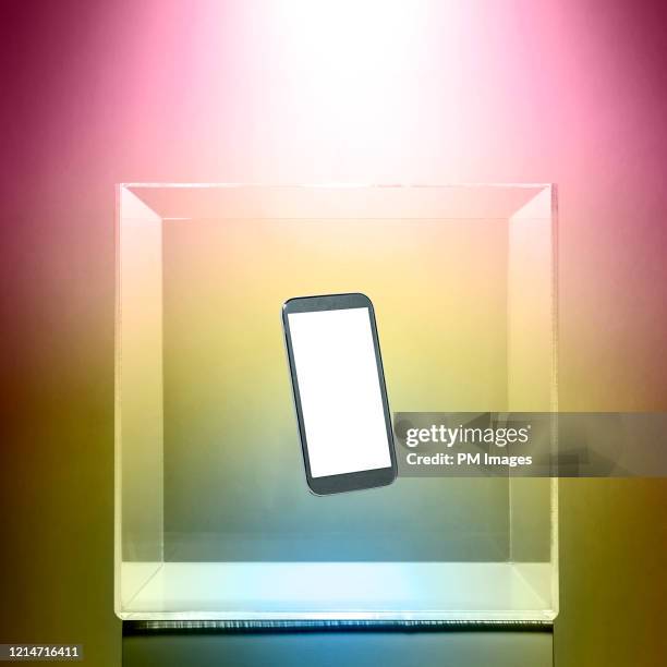 cell phone in a clear box - transparent box stock pictures, royalty-free photos & images