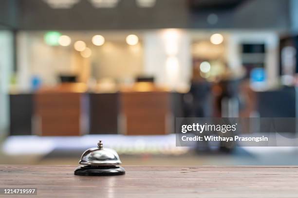 hotel service bell on a table white glass and simulation hotel background. concept hotel, travel, room - hotel bell stockfoto's en -beelden