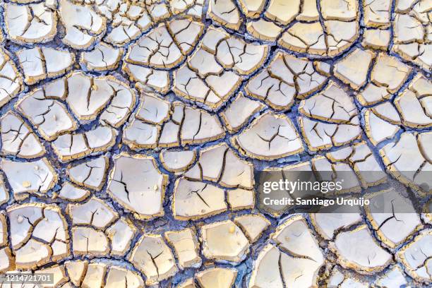 cracked dry soil in rio tinto riverbed - mud riverbed stock pictures, royalty-free photos & images