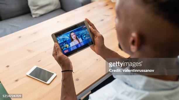 businessman in isolation watching newscaster presenting the breaking news during in a state of emergency - the media stock pictures, royalty-free photos & images