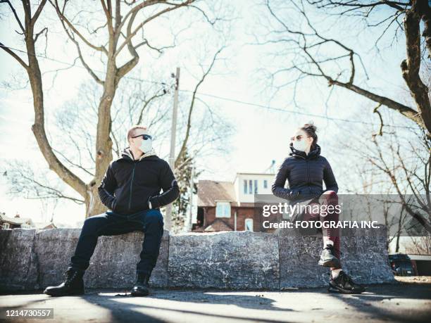 covid-19, young couple meeting outside - covid dating stock pictures, royalty-free photos & images
