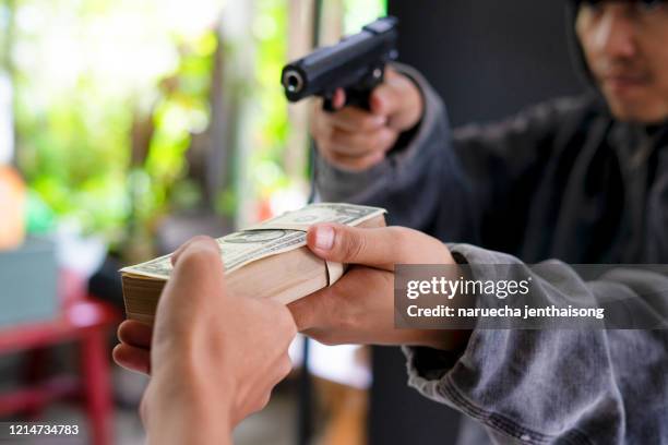 armed robbers used the gun to robbery the money, uses gun in armed robbery, armed robbers, - bank robber stock pictures, royalty-free photos & images