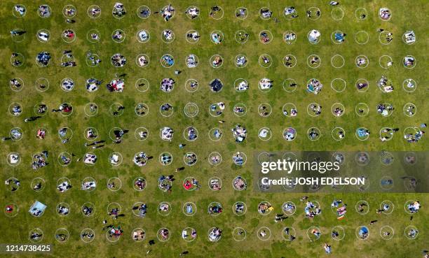 An aerial view shows people gathered inside painted circles on the grass encouraging social distancing at Dolores Park in San Francisco, California...