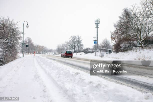 snowcovered road during a blizzard - covered car street stock pictures, royalty-free photos & images