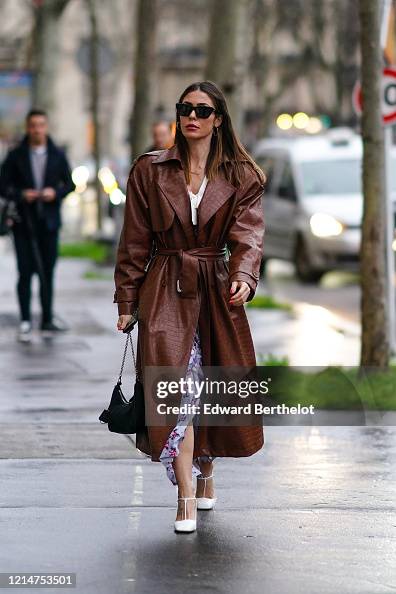 A guest wears sunglasses, a brown leather long trench coat with... News ...