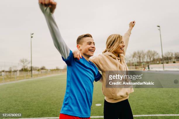 cheerful family playing soccer together - match sport stock pictures, royalty-free photos & images