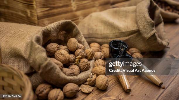 walnuts spilled from the sack - nutshell stock pictures, royalty-free photos & images