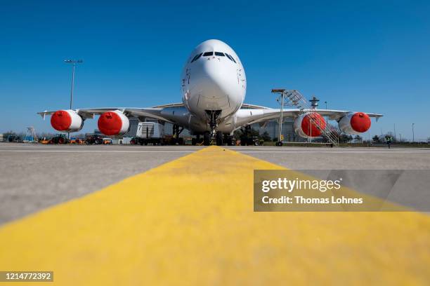 An Airbus A380-800 passenger plane of German airline Lufthansa stands parked and pulled from service at Frankfurt Airport on March 25, 2020 in...