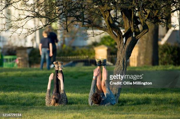 People are seen exercising in Primrose Hill on March 25, 2020 in London, United Kingdom. British Prime Minister, Boris Johnson, announced strict...