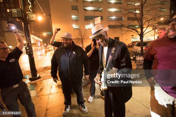 View of American Blues musician Buddy Guy , along with a group of unidentified others, outside of his nightclub, Buddy Guy's Legends, Chicago...