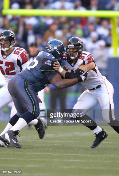 Patrick Kerney of the Atlanta Falcons fights off the block of Floyd Womack of the Seattle Seahawks during an NFL football game January 2, 2005 at...