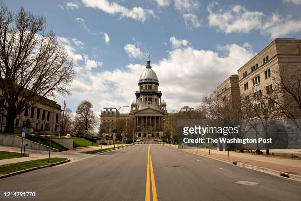 The Illinois State Capitol building stands among empty streets in Springfield, Illinois on April 9, 2020.