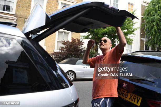 Number 10 Downing Street special advisor Dominic Cummings closes the boot of his car outside his home in London on May 23, 2020 after allegations he...
