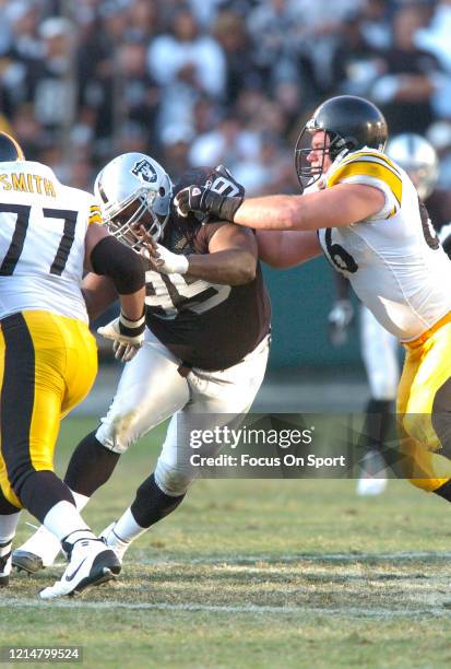 Warren Sapp of the Oakland Raiders fights off the block of Alan Faneca of the Pittsburgh Steelers during an NFL football game on October 29, 2006 at...