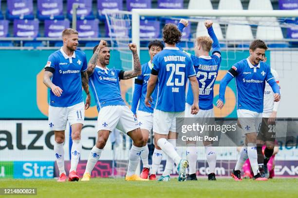 Victor Palsson of SV Darmstadt 98 celebrates with teammates following scoring his side's fourth goal during the Second Bundesliga match between SV...