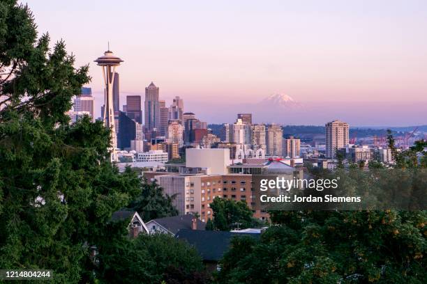 view of the space needle and mt. rainier on a clear seattle day. - seattle sunset stock pictures, royalty-free photos & images