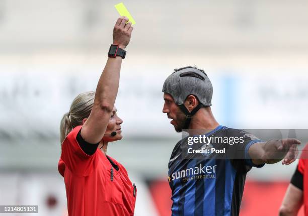 Klaus Gjasula of SC Paderborn 07 is shown a yellow card by referee Bibiana Steinhaus during the Bundesliga match between SC Paderborn 07 and TSG 1899...