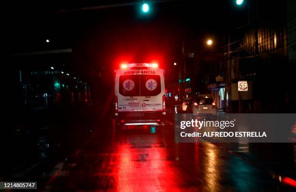 View of the M16 ambulance rushing for an emergency call for a COVID-19 possible case in Nezahualcoyotl municipality, state of Mexico, late on May 22,...