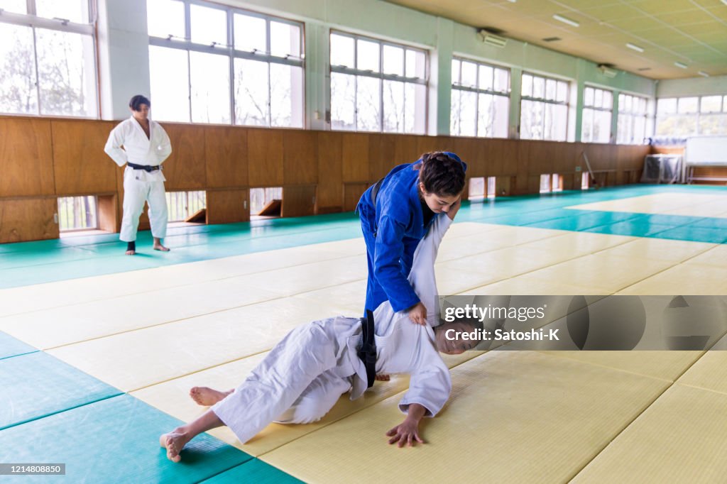 Young female Judo athlete attacking with “Nage Waza��” throwing technique