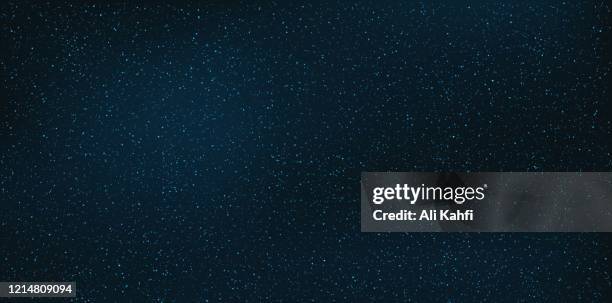 galaxy and stars in dark night sky background - star field background stock illustrations