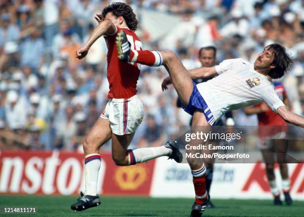 Bryan Robson of England evades a high challenge from Rene Girard of France during a 1982 FIFA World Cup Group 2 match at the San Mames Stadium on...