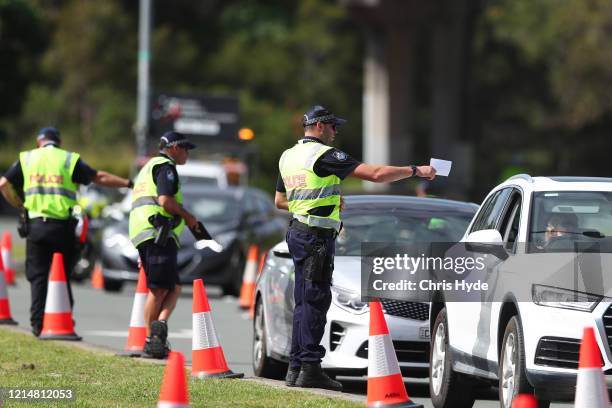 Queensland Police stop vehicles at a Police checkpoint set up at the Queensland and New South Wales border in Coolangatta on March 26, 2020 on the...